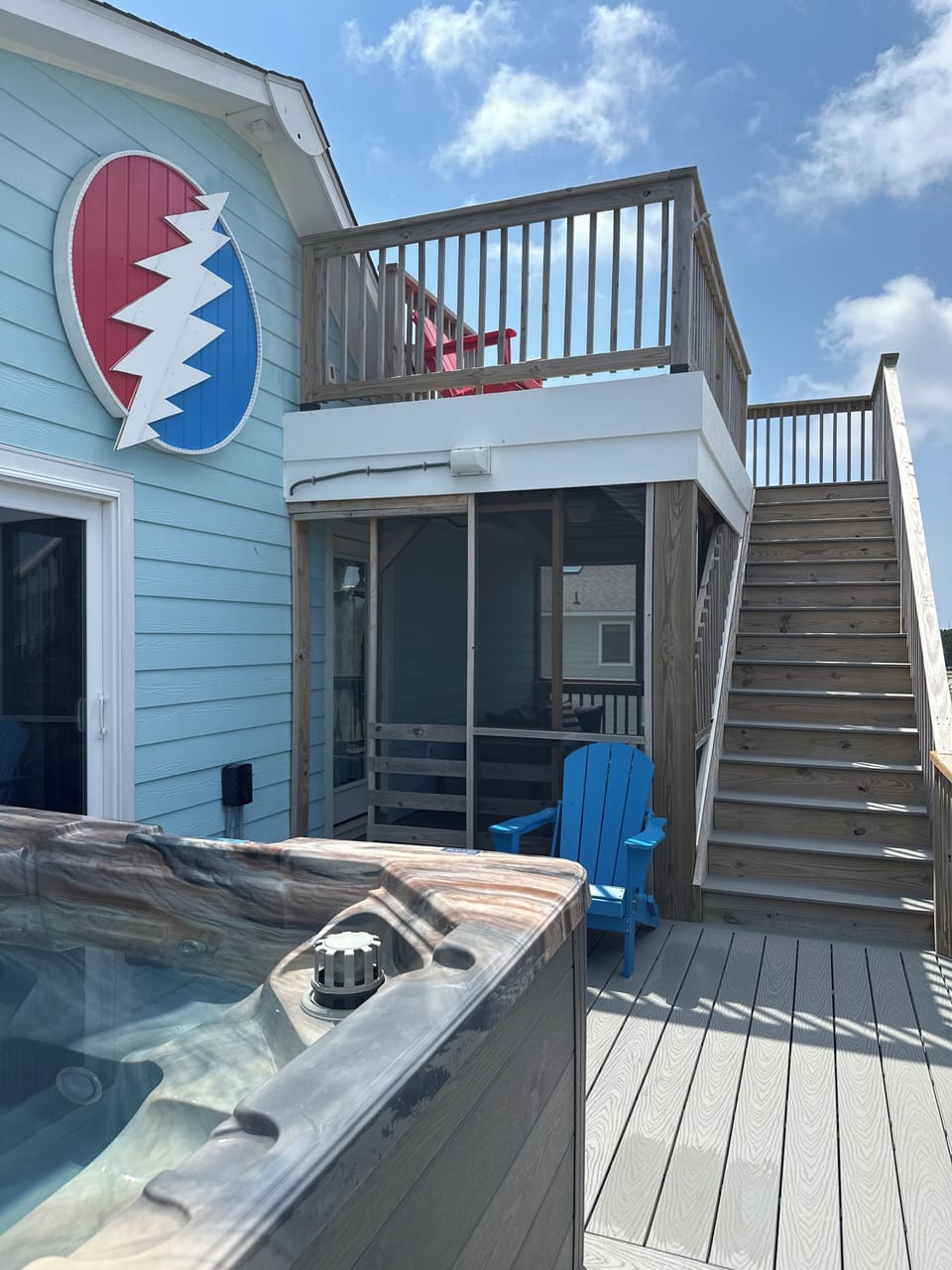 2nd level hot tub deck with shaded & screened sitting area with an outdoor couch
