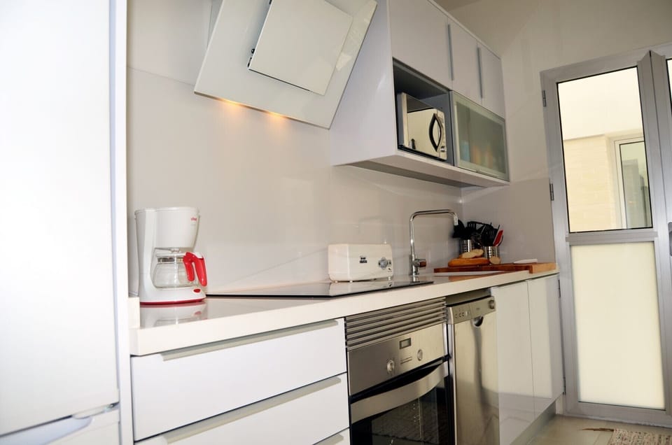 Spacious and modern kitchen with high quality appliances including a full kitchen with oven, hob, dishwasher and washing machine.