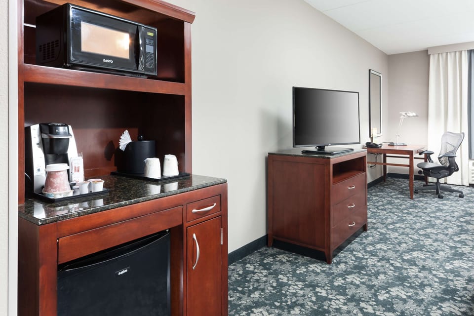 Premium bedding, desk, laptop workspace, blackout drapes