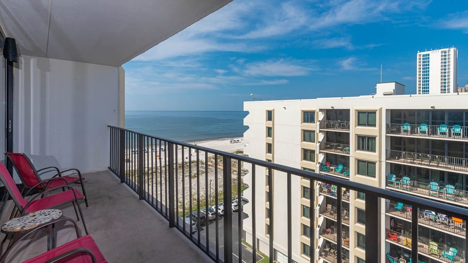 Enjoy a relaxing view from the balcony with seating, overlooking the beach and tranquil waters