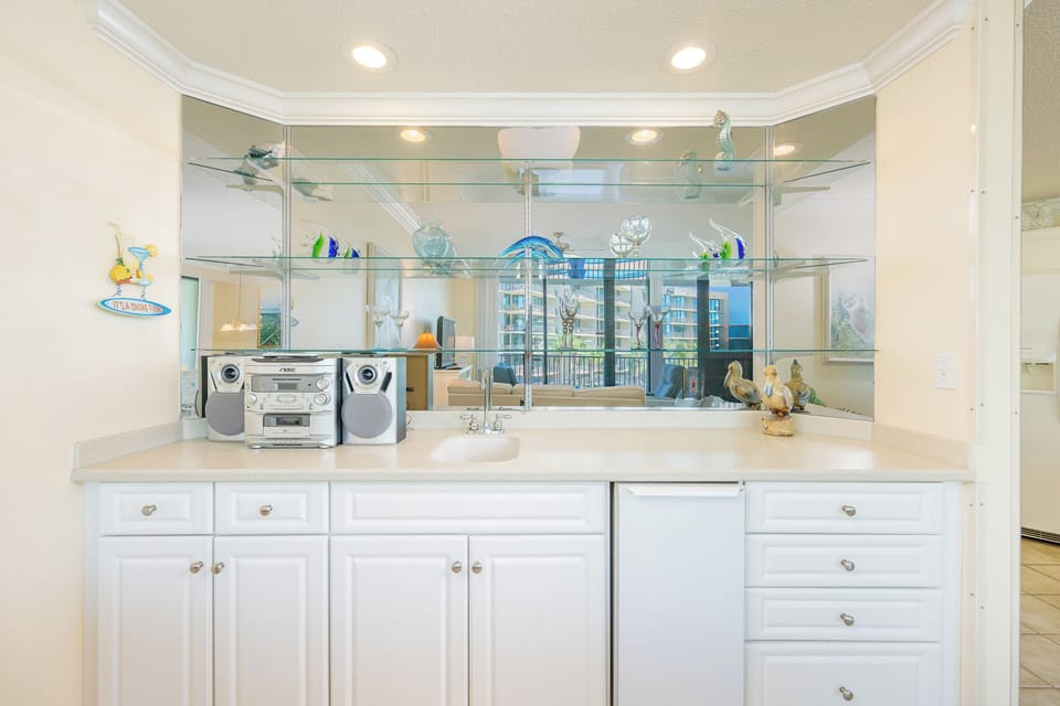 Enjoy refreshing drinks from the wet bar while admiring the inviting views and stylish coastal accents