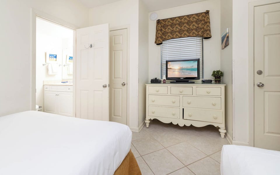 Relax in this guest room featuring cozy queen beds, a TV for entertainment, and an en-suite bathroom