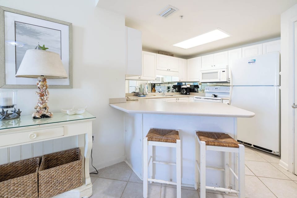 Prepare meals and enjoy morning coffee at the kitchen bar, featuring stylish stools and coffee maker with Keurig addition