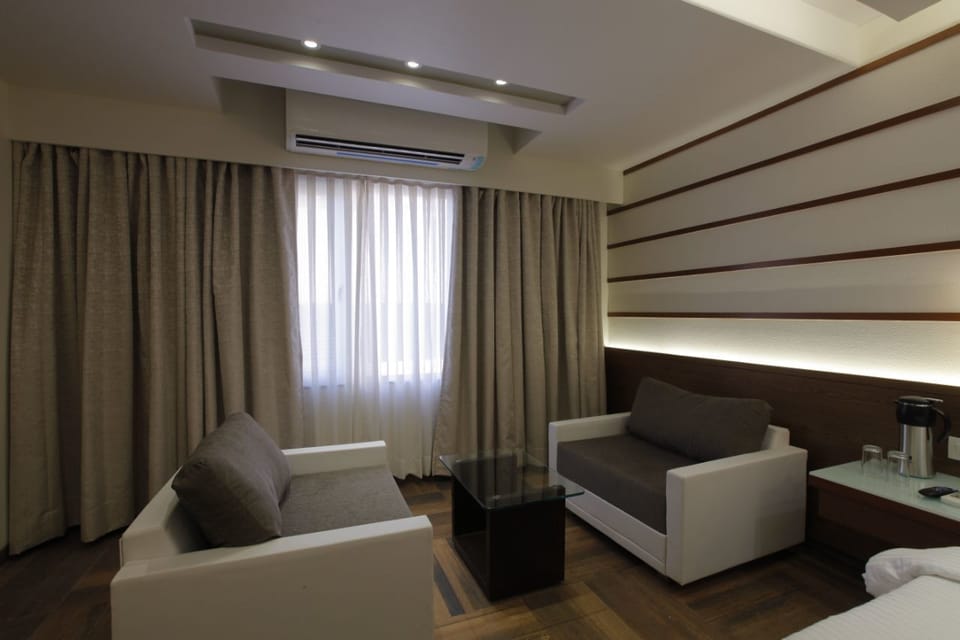 Superior Suite, 1 King Bed | Living room | 32-inch flat-screen TV with cable channels, TV
