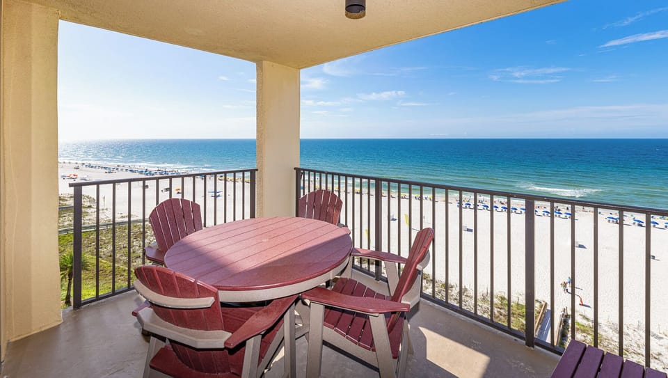 Relax on the balcony with a round table and Adirondack chairs, overlooking the beach and tranquil turquoise waters