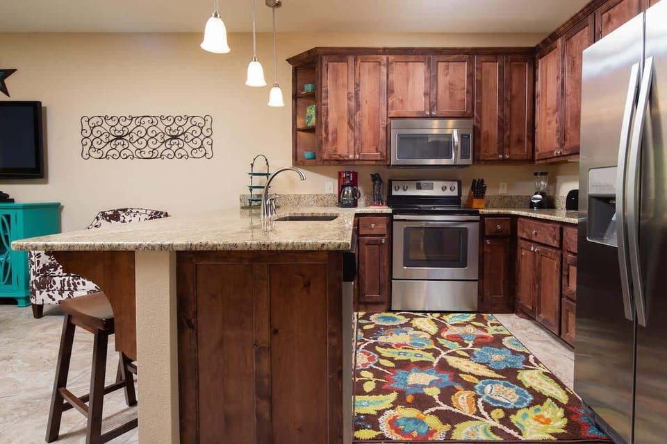  a fully stocked kitchen including toaster, blender, coffee maker, and more.
