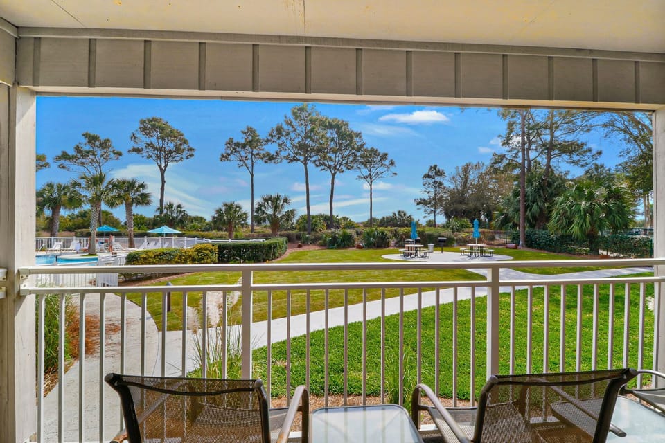 Balcony oceanfront view - View from the balcony to the walkway to the oceanfront pool and grill area.