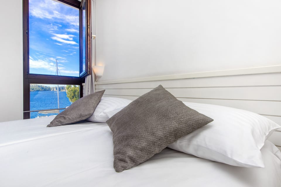 Desk, iron/ironing board, bed sheets