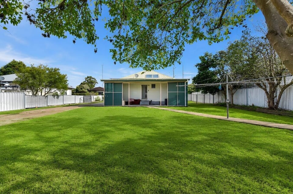 House Exterior (Back). Back yard and outdoor exterior patio area with lounges, outdoor setting and BBQ.