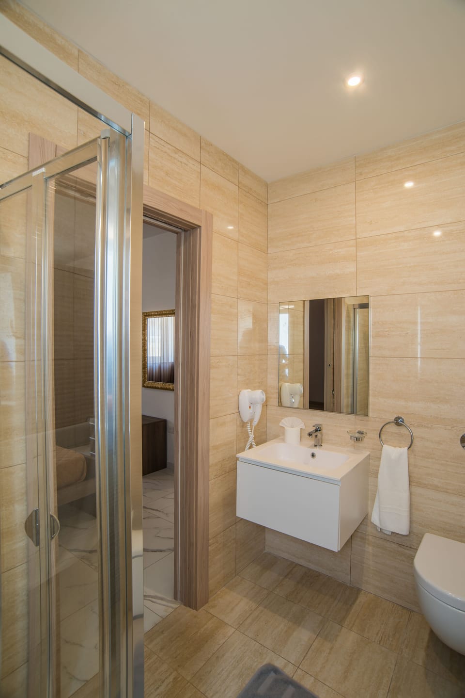 En-suite Shower of Bedroom 4 with; vanity and hair dryer 