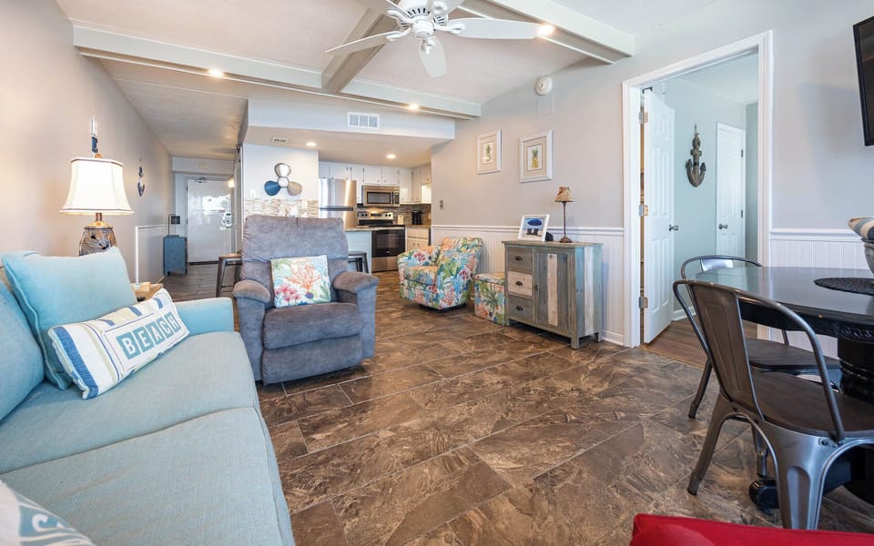 This inviting living area features comfortable seating, a stylish dining space, and a glimpse of the well-equipped kitchen