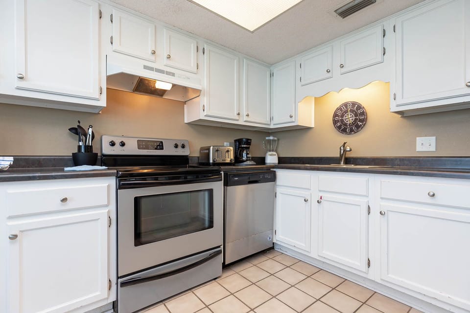 This kitchen features stainless appliances, granite countertops, and a coffee maker for your convenience