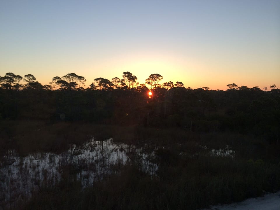 Sunrise over the State Park & bayside from 'Garden Square' (King bedroom)