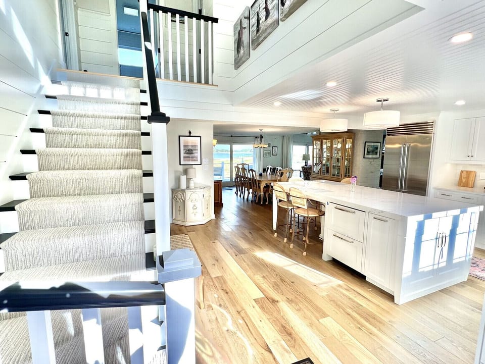 Front hall opens into chef’s kitchen, large dining area, family room & sunroom