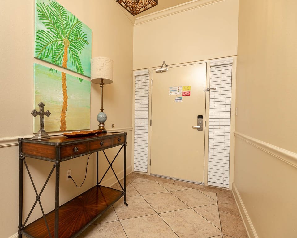Step into a warm welcome with palm art and inviting decor that sets the perfect beach vibe for your stay