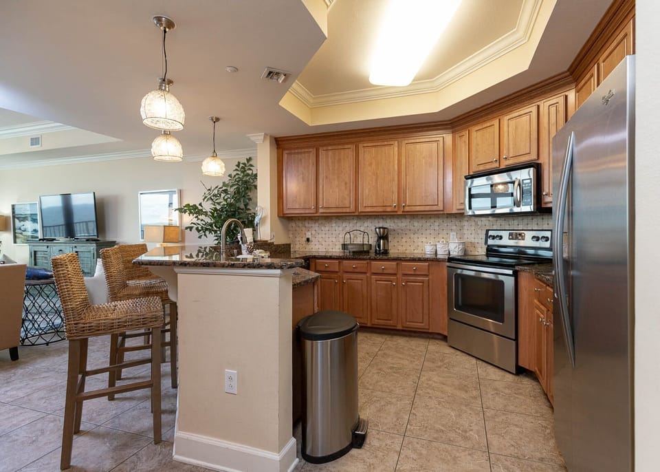 This kitchen features stainless appliances, granite countertops, and a cozy breakfast bar, perfect for morning coffee