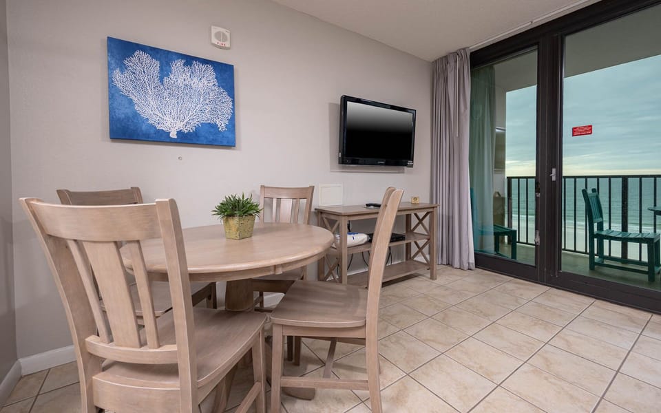 Dine at the round table while enjoying views through the sliding glass doors leading to outdoor seating