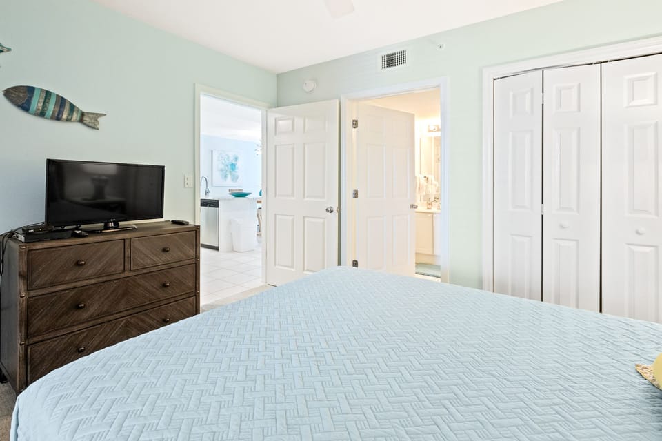 Flat screen TV and ensuite bath in guest bedroom