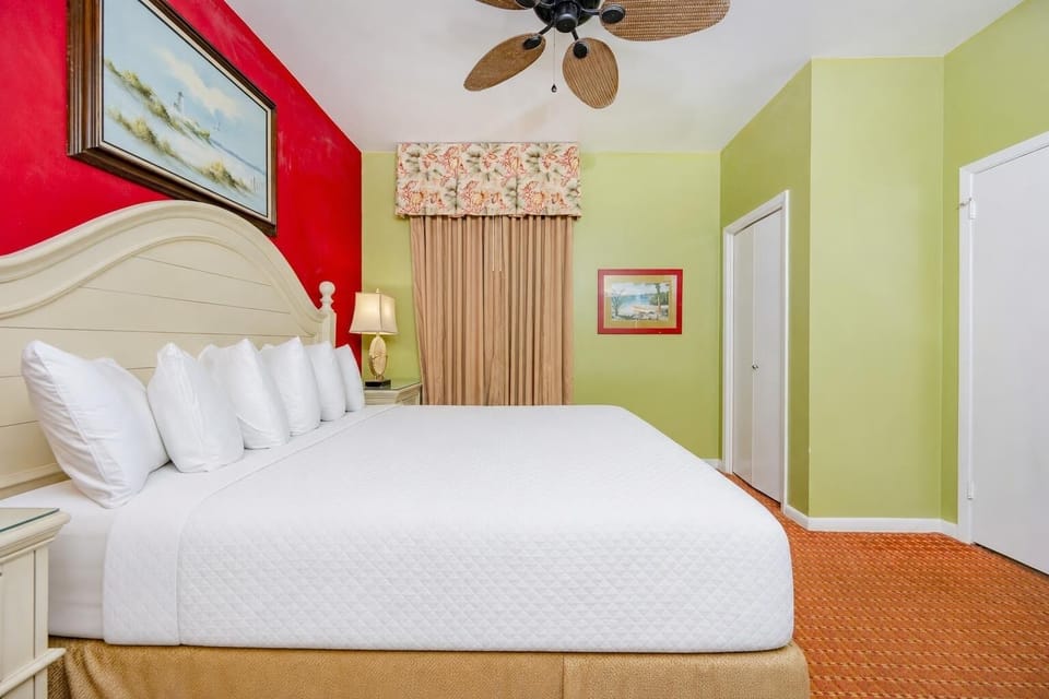 King suite with fluffy pillows, colorful walls, and a cozy atmosphere for relaxation