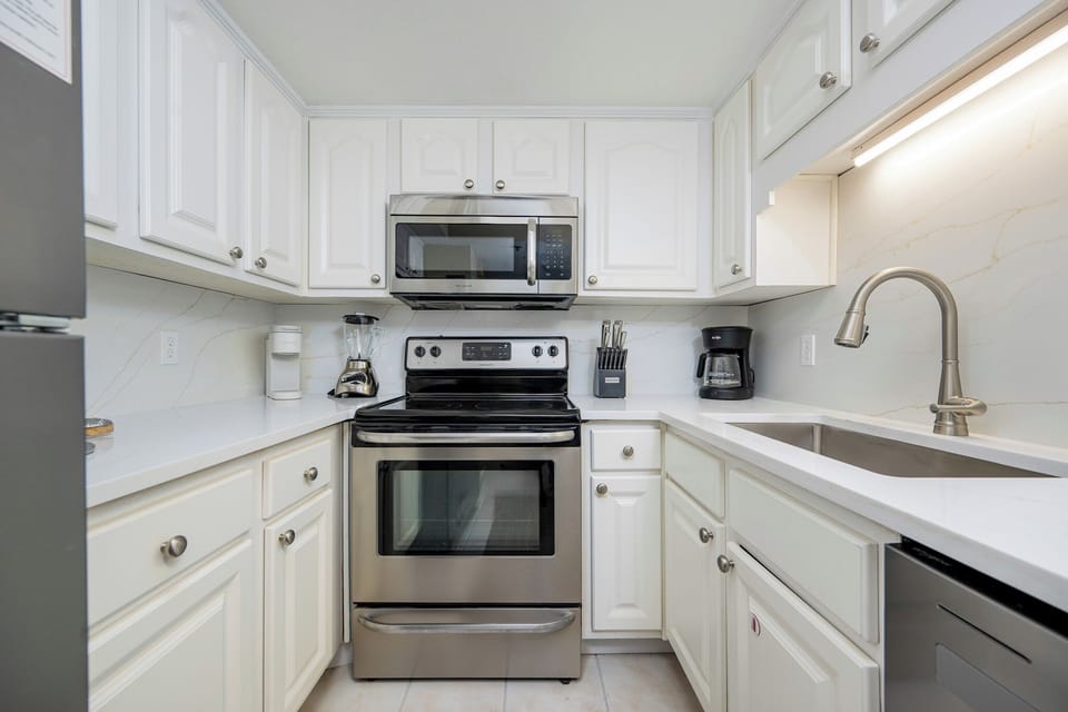 Prepare your favorite meals in this inviting kitchen, equipped with sleek appliances and ample counter space