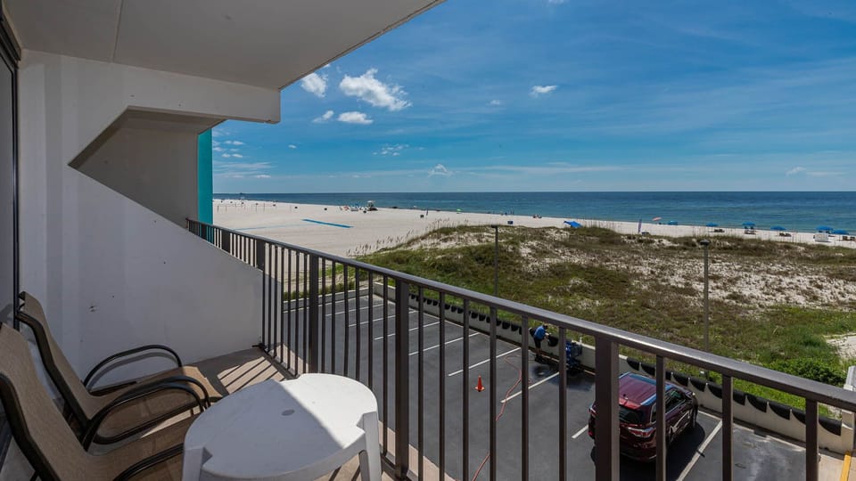 Enjoy a relaxing view from the balcony overlooking the beach, perfect for unwinding after a day of fun