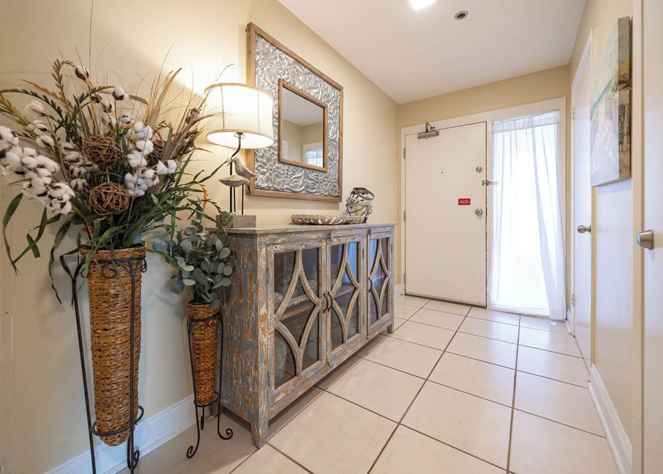 Step into a welcoming entryway featuring stylish decor, natural elements, and ample space for your belongings