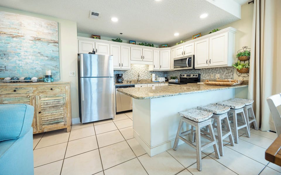 Enjoy preparing meals in this stylish kitchen with granite countertops and seating at the breakfast bar