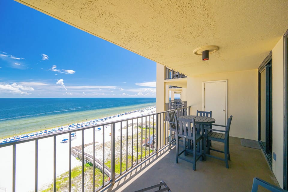 Enjoy breathtaking views from the spacious balcony, featuring a stylish table and chairs for relaxing seaside moments