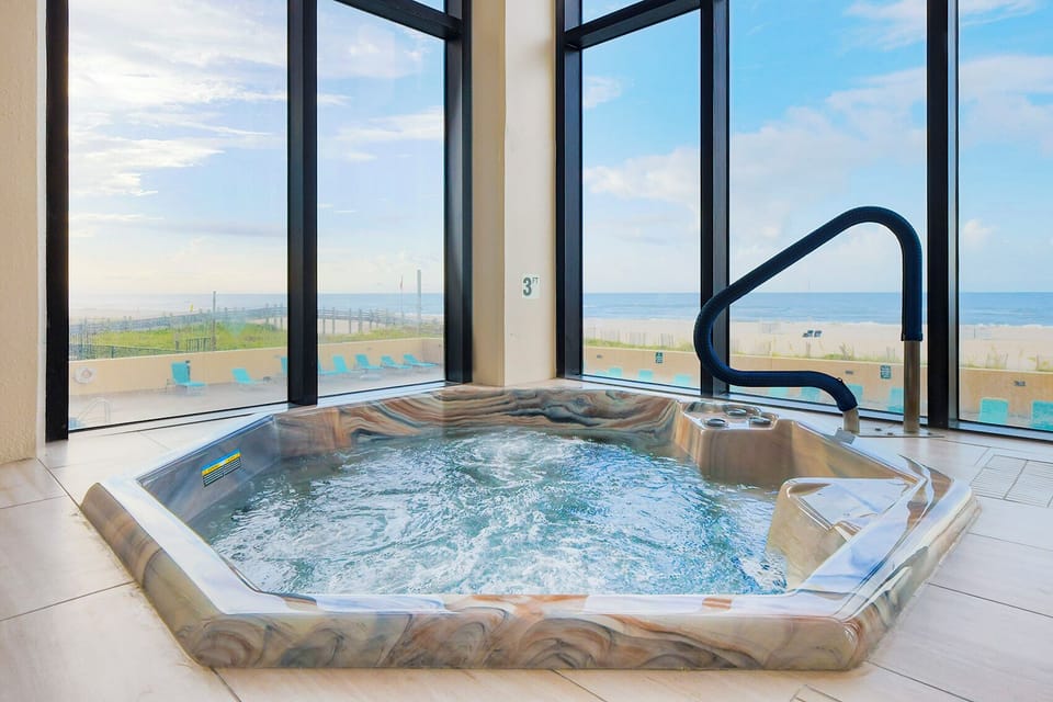 Take a dip in the hot tubs overlooking the beach and pool area outside of Phoenix II in Orange Beach