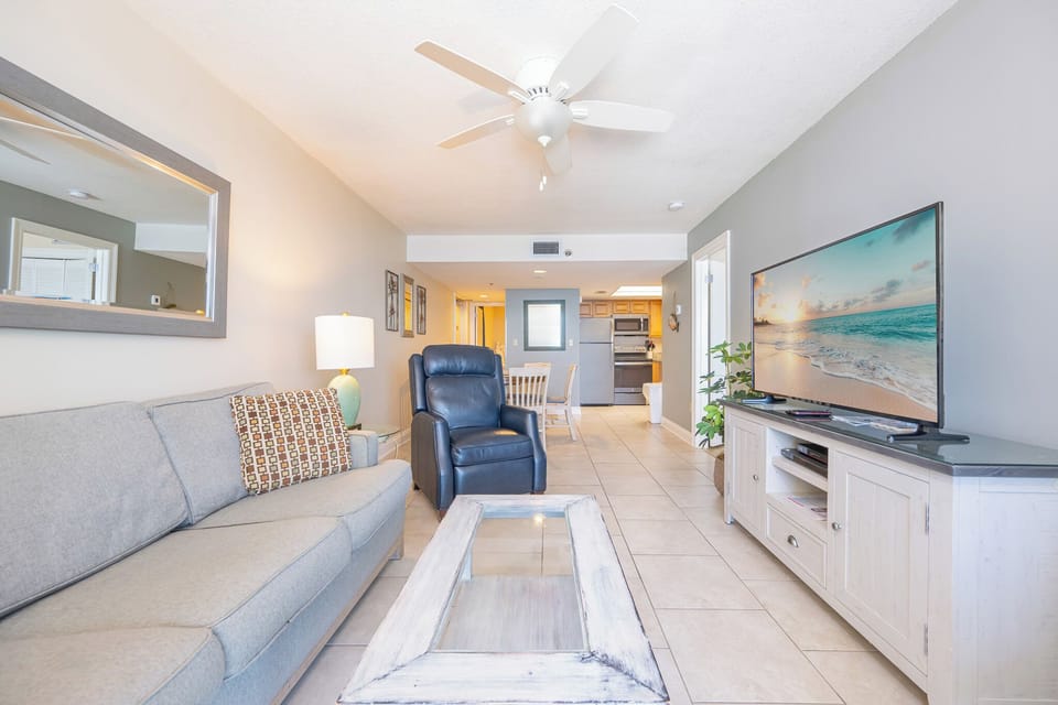 Living area featuring a cozy sofa with queen sleeper, modern decor, and a beautiful view from the balcony