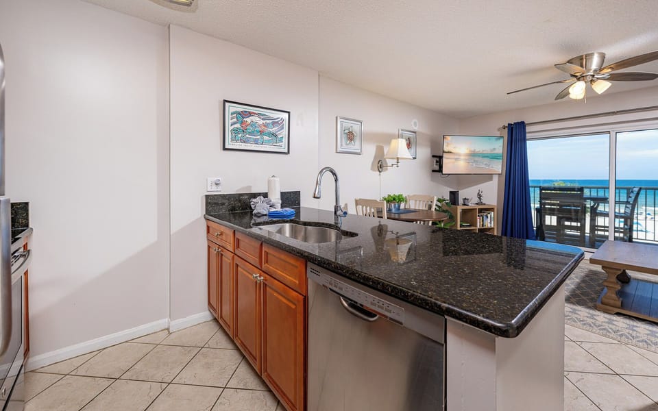 This kitchen features rich wood cabinetry, sleek stainless appliances, and a cozy breakfast bar perfect for morning coffee