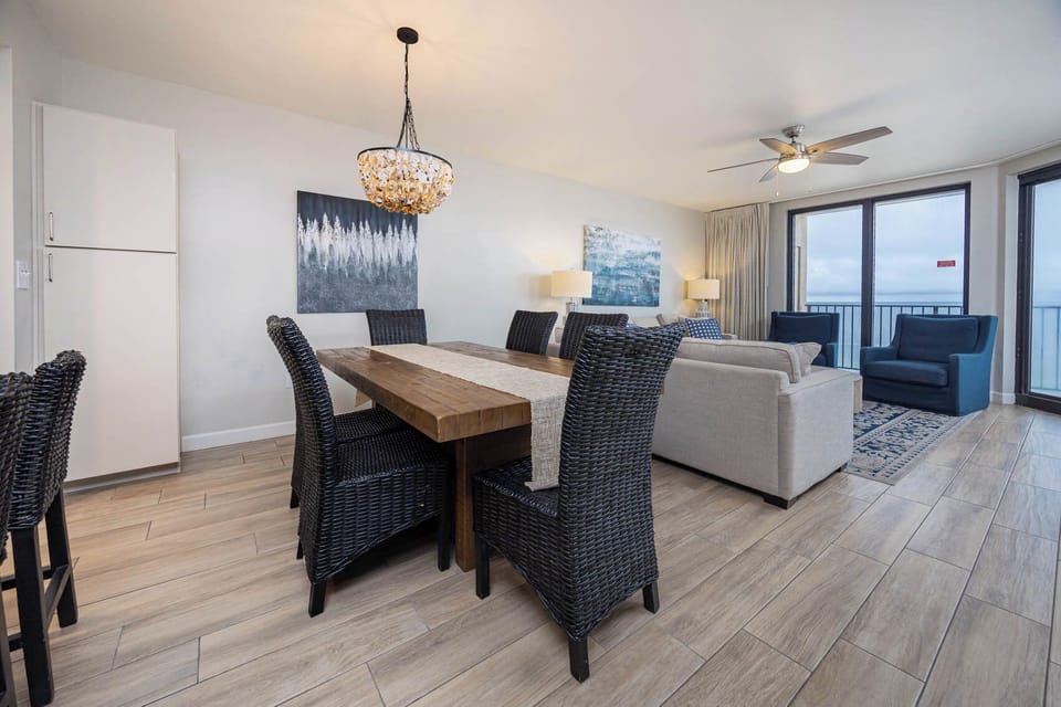 Gather around the rustic dining table, surrounded by comfortable seating and stylish decor, perfect for family meals
