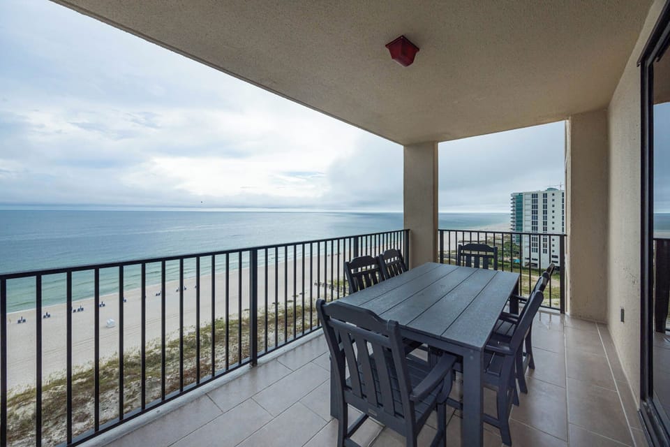 Dine al fresco at the spacious table on the balcony, enjoying refreshing views of the tranquil waters and beach