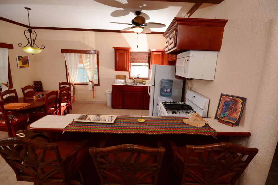 Another view of kitchen with additional chair back bar stools seating for 3 