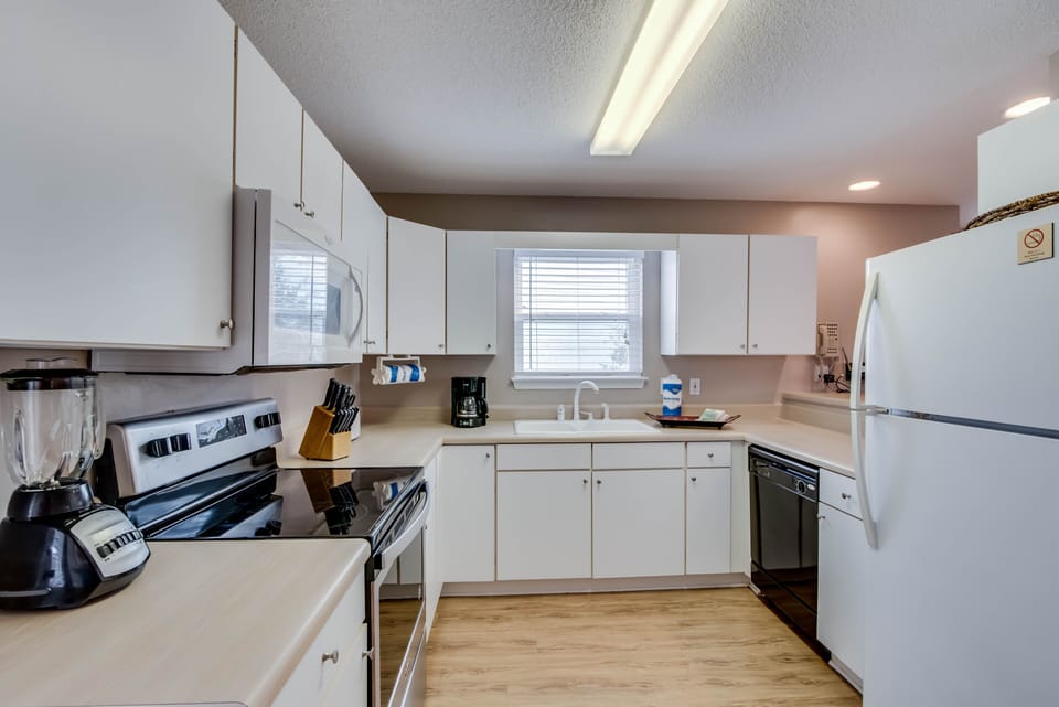 Kitchen - The kitchen offers both large and small appliances, and is fully stocked with pots, pans, bake ware, dishes, and flatware.