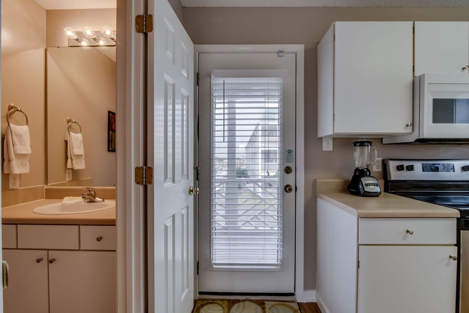 Half Bath and Balcony Access - A half bath is located just off the kitchen on the main floor for your convenience. Also located in this space is access to an outdoor balcony.