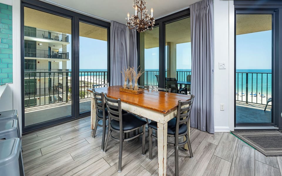 Gather around the rustic dining table while enjoying beach views from the balcony