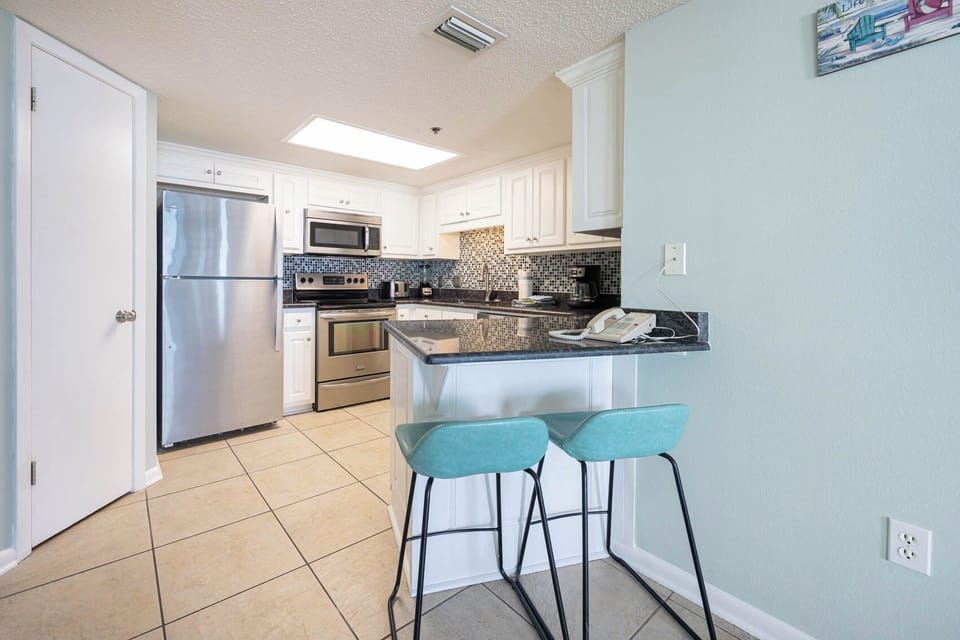 Enjoy casual meals at the sleek bar seating, surrounded by stylish decor in the kitchen