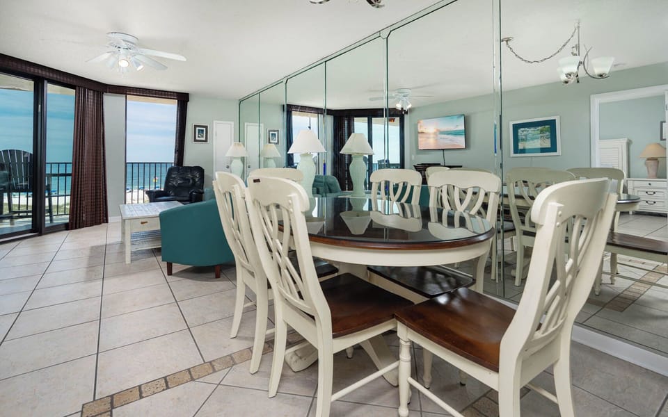 Gather around the dining table, enjoying beachfront views through from the balcony