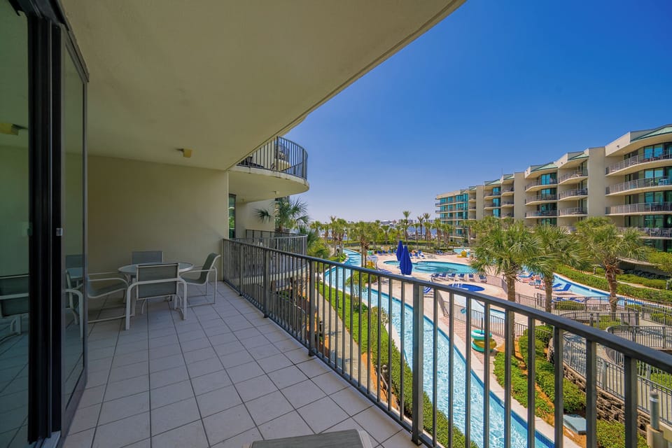 Breathe in the coastal breeze as you unwind on the balcony overlooking the tranquil poolside and lush surroundings