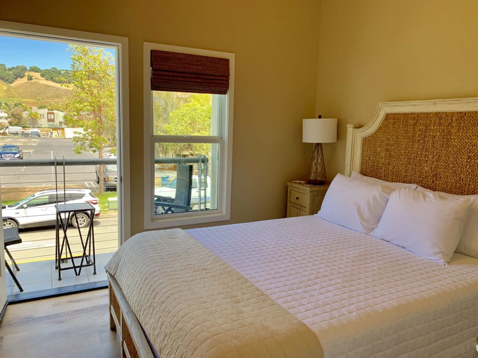 Bedroom 2 balcony opens to big Avila Beach mountain views. Balcony area overlooks 1st St.