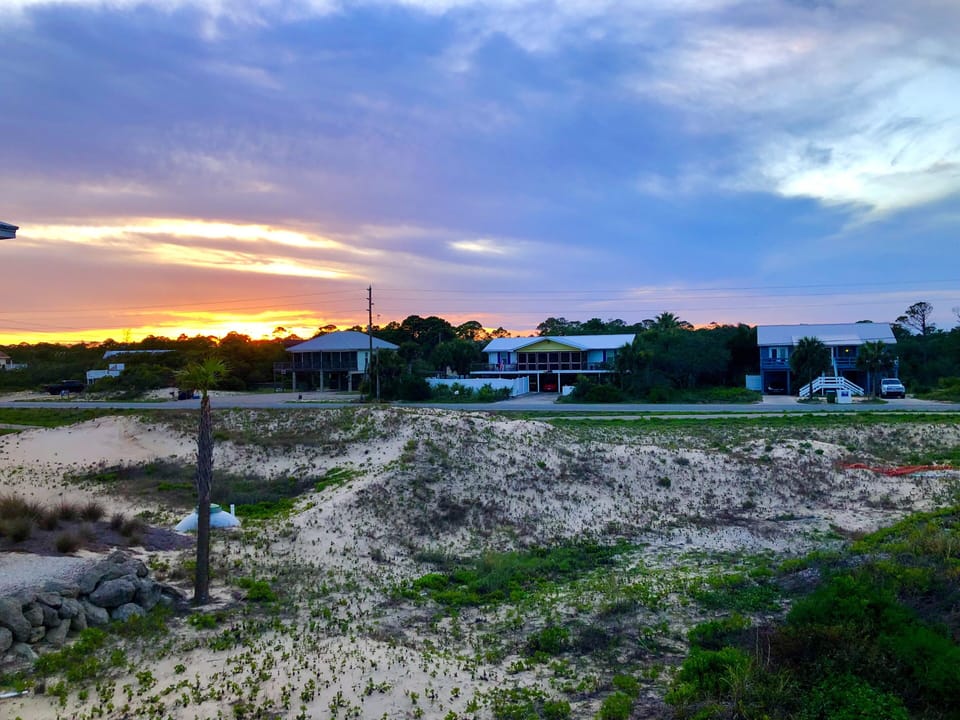 Photo of wide open space from back of house.. Sunset behind dunes… EPIC!