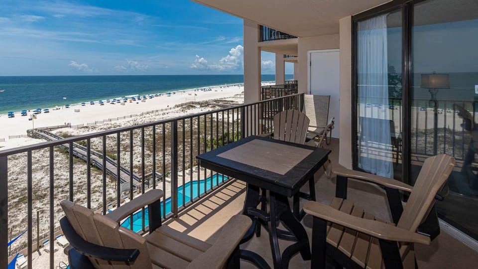 Enjoy your morning coffee on the balcony, overlooking the beach and vibrant blue waters