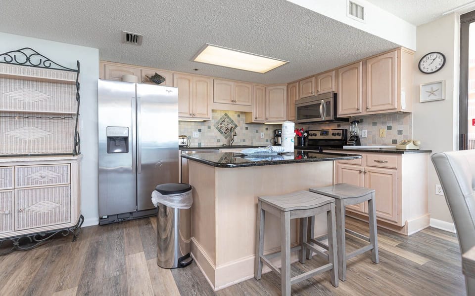 Prepare meals in this inviting kitchen, featuring stainless appliances and a spacious island for gathering and dining