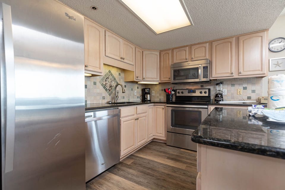 Cook and gather in this inviting kitchen, featuring stainless appliances and elegant cabinetry