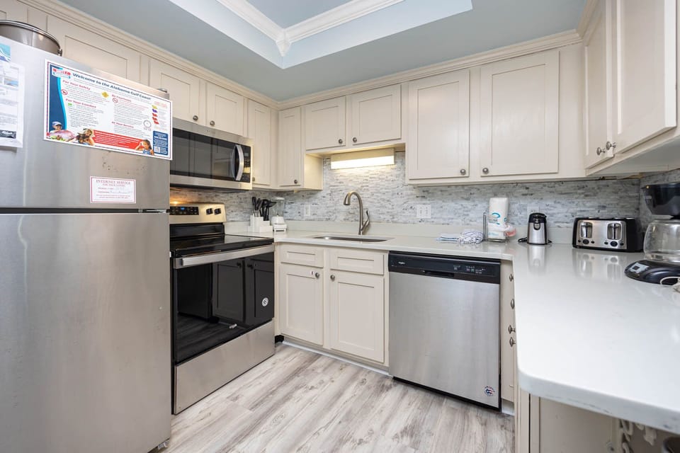 This kitchen features stainless appliances, a coffee maker, and elegant cabinetry, perfect for your culinary adventures