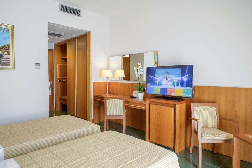 Superior Triple Room | Minibar, in-room safe, desk, laptop workspace