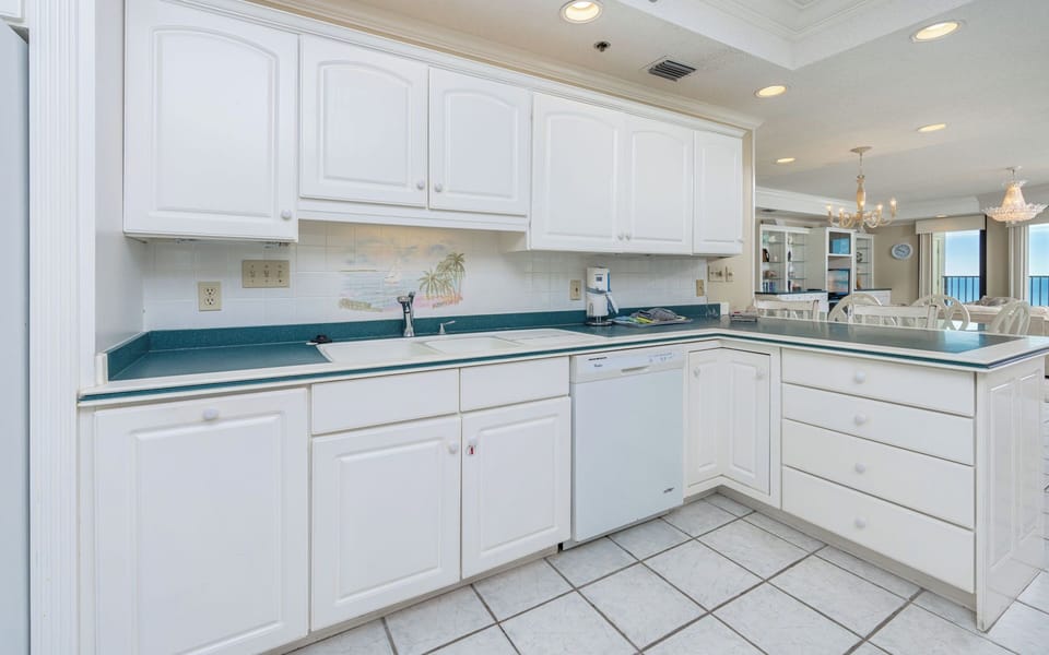 Bright and stylish open kitchen design featuring ample counter space, white cabinetry, and a charming view