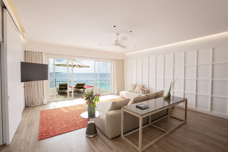 Superior Water Villa with Pool | Living area | 50-inch LCD TV with cable channels, TV, iPod dock