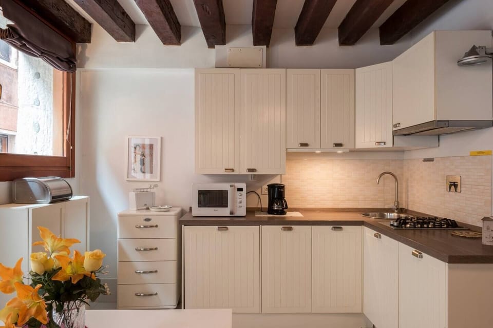 Deluxe Triple Room, Canal View | Private kitchen | Full-size fridge, microwave, stovetop, dishwasher